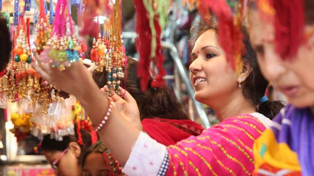 As Raksha Bandhan is just a day away, city markets are flooded with colourful rakhis. On Saturday there were rushed sales, last-minute shopping of gifts and sweets as the city geared up for the festival that celebrates the brother-sister bond of love. The simple bond of promise of safeguarding a sister, has acquired a modern, swanky avatar in this age of marketing. (Himanshu Vyas / HT Photo)