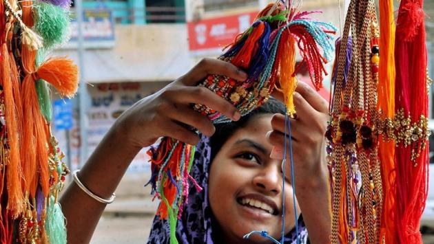 A girl selecting Rakhi at a shop in Chikmaglur, Karnataka . The craze for choosing the best rakhis for their brothers can be seen among the women and young girls. (PTI)