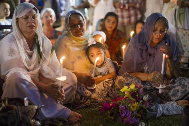 People attend a candle light vigil at the Oak Creek Civic Center on August 7, 2012, two days after a gunman shot to death six Sikhs at a gurdwara in Oak Creek, Wisconsin.(AP File)