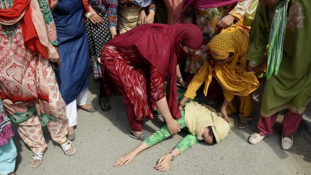 A Kashmiri woman lies on the ground after fainting fainted during the funeral procession of slain militant Yawar Nissar at Shipora in Anantnag, South of Srinagar. (Tauseef MUSTAFA / AFP) A Kashmiri woman lies on the ground after fainting fainted during the funeral procession of slain militant Yawar Nissar at Shipora in Anantnag, South of Srinagar. (Tauseef MUSTAFA / AFP)