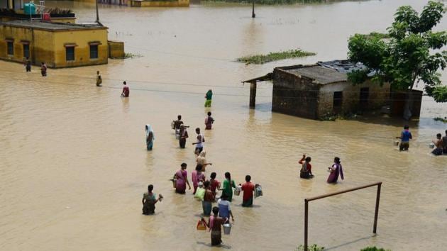 Indian residents affected by flooding naviagate flodwaters to collect relief materials in Udaynarayanpur, some 83kms west of Kolkata. Lightning killed 21 people in eastern India as large swathes of the country reel under the worst floods in years that have left hundreds dead and millions displaced, officials said July 31. (Dibyangshu SARKAR / AFP) Indian residents affected by flooding naviagate flodwaters to collect relief materials in Udaynarayanpur, some 83kms west of Kolkata. Lightning killed 21 people in eastern India as large swathes of the country reel under the worst floods in years that have left hundreds dead and millions displaced, officials said July 31. (Dibyangshu SARKAR / AFP)