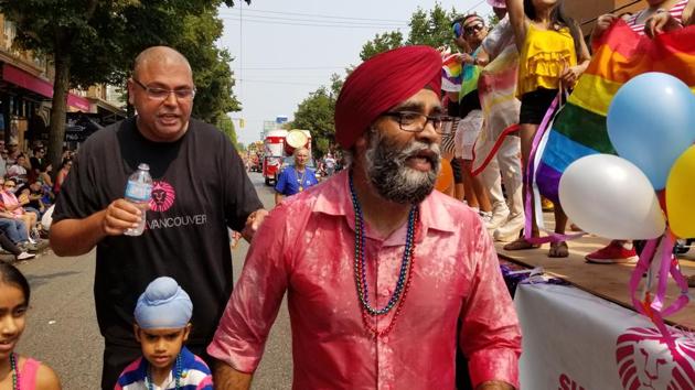 Canada’s Minister of National Defence Harjit Sajjan next to Sher Vancouver’s Pride of Bollywood VI float, standing alongside Alex Sangha, Sher Vancouver’s founder.(Image courtesy: Sher Vancouver)