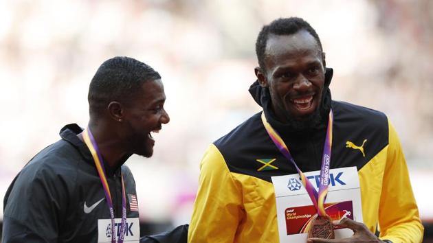 Gold medallist Justin Gatlin (L) and bronze medallist Usain Bolt share a light moment during the podium ceremony of the men’s 100m event at the IAAF World Championships of Athletics in London on Sunday. (AFP)