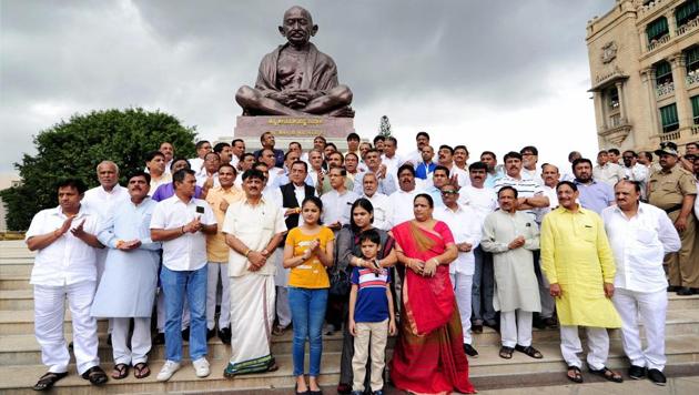 Gujarat Congress MLAs pose in front of the statue of Mahatama Gandhi during their visit to the Karnataka assembly in Bengaluru. (PTI) Gujarat Congress MLAs pose in front of the statue of Mahatama Gandhi during their visit to the Karnataka assembly in Bengaluru. (PTI)