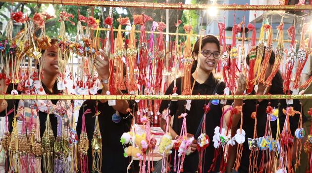 Girls choose rakhis for their brothers at a stall in Pune. (Rahul Raut/HT PHOTO)