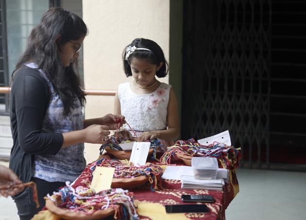 Two young girls engrossed in selecting the perfect rakhi. (Rahul Raut/HT PHOTO)