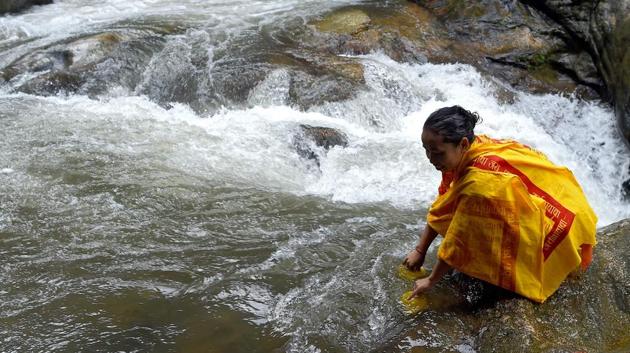 A Nepalese devotee collects water from Bagmati river. Apart from its religious importance, the Pashupatinath Temple is also regarded as the saviour of Nepal at the times of difficulties. (PRAKASH MATHEMA / AFP) A Nepalese devotee collects water from Bagmati river. Apart from its religious importance, the Pashupatinath Temple is also regarded as the saviour of Nepal at the times of difficulties. (PRAKASH MATHEMA / AFP)