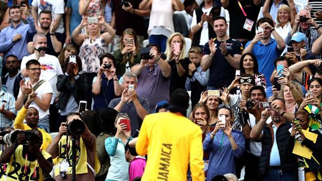 Usain Bolt obliges the photographers and the fans after the podium ceremony of the men’s 100m event at the IAAF World Championships of Athletics in London on Sunday. (Getty Images)