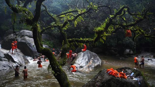 Nepalese Hindu devotees bath and collect water in the Bagmati river on their way to the Pashupatinath temple to offer prayers to Lord Shiva during Shravan festivities in Sundarijal, on the outskirts of Kathmandu. According to the Nepalese calendar, Shravan is considered the holiest month of the year with each Monday of the month known as Shravan Somvar when worshippers offer prayers for a happy and prosperous life. (PRAKASH MATHEMA / AFP) Nepalese Hindu devotees bath and collect water in the Bagmati river on their way to the Pashupatinath temple to offer prayers to Lord Shiva during Shravan festivities in Sundarijal, on the outskirts of Kathmandu. According to the Nepalese calendar, Shravan is considered the holiest month of the year with each Monday of the month known as Shravan Somvar when worshippers offer prayers for a happy and prosperous life. (PRAKASH MATHEMA / AFP)