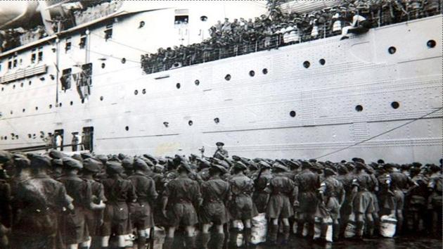 Governor General Lord Louis Mountbatten (C) delivers an address to soldiers from The Royal Norfolk Regiment on the quayside in Mumbai, as they prepare to embark on the SS Georgic bound for Britain, making them the first British Army unit to leave Indian soil after the country achieved independence, on August 17, 1947. (AFP) 