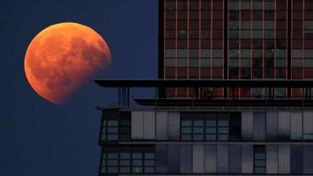 A partial lunar eclipse is pictured beside a building in Berlin, Germany. A penumbral lunar eclipse takes place when the moon moves through the faint, outer part of Earth’s shadow. (REUTERS)