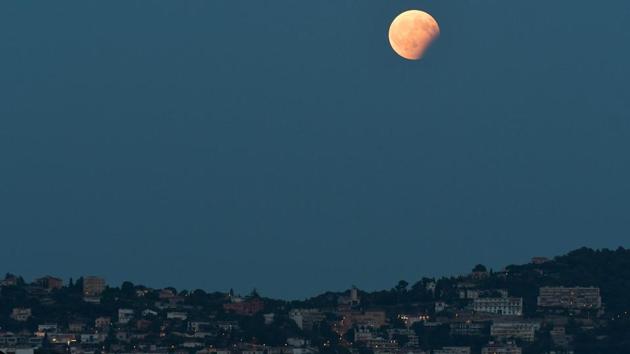 Partial lunar eclipse as seen in Nice southern France. The total duration of the penumbral eclipse was five hours and one minute and that of the partial eclipse one hour and 55 minutes. (YANN COATSALIOUAFP)