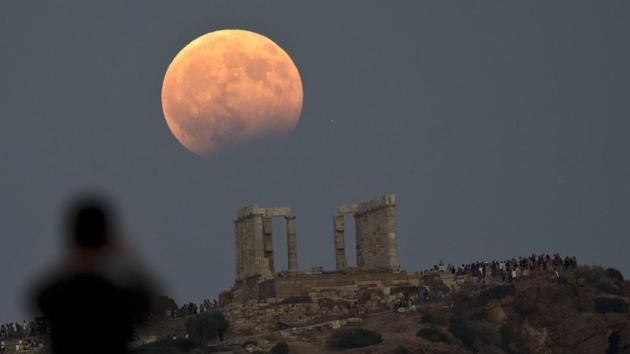 Most of Asia, Africa, Europe, Australia and Antarctica received their own celestial show, a partial lunar eclipse on Monday night. The phenomenon occurs when the moon moves through the outer part of the Earth’s shadow, blocking a part of the sunlight from reaching the moon and causing it to appear larger than normal. An interesting aspect of lunar eclipse is that everywhere on a earth from where the moon is visible during eclipse, the time will be the same. (Petros Giannakouris/AP)