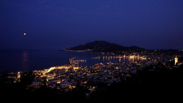 The August moon in seen in a partial lunar eclipse rise over the Ionian sea in Zakynthos island. (Petros Karadjias/AP)