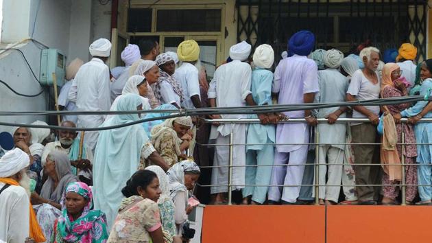 Villagers queue to receive their pension, outside a bank in Amritsar on July 27, 2017. (AFP) Villagers queue to receive their pension, outside a bank in Amritsar on July 27, 2017. (AFP)