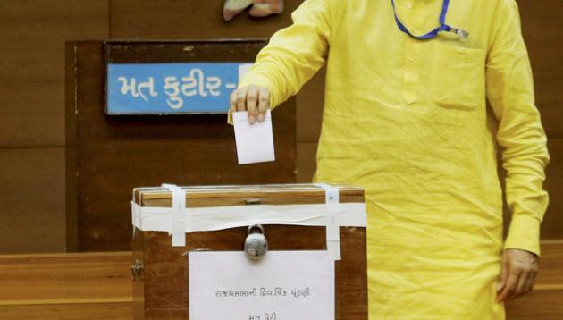 A Gujarat MLA casting his vote for Rajya Sabha election at the Secretariat in Gandhinagar on Tuesday. (PTI Photo) A Gujarat MLA casting his vote for Rajya Sabha election at the Secretariat in Gandhinagar on Tuesday. (PTI Photo)