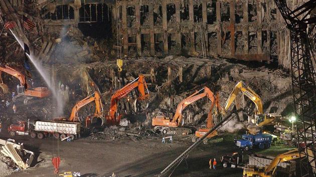 Workers and heavy machinery continue the clean up and recovery effort in front of the remaining facade of 1 World Trade Center at ground zero in New York. (AP File Photo) Workers and heavy machinery continue the clean up and recovery effort in front of the remaining facade of 1 World Trade Center at ground zero in New York. (AP File Photo)