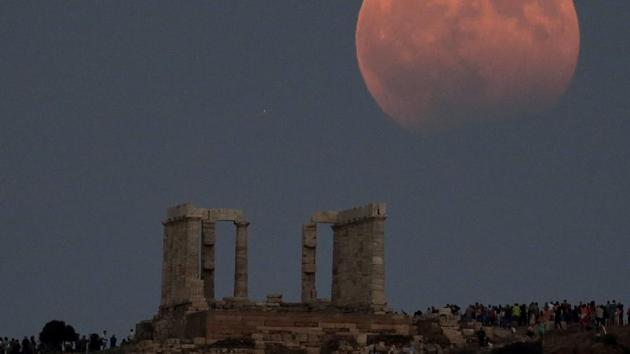 Temple of Poseidon is seen as a full moon is partially covered by the Earth's shadow during a lunar eclipse in east of Athens, Greece. (Costas Baltas/REUTERS)
