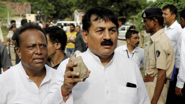 Senior Congress leader Bharatsinh Solanki hold a stone that was allegedly thrown at party vice president's Rahul Gandhi's car during his visit to flood-hit Dhanera village in Gujarat’s Banaskantha district last week. (PTI file) Senior Congress leader Bharatsinh Solanki hold a stone that was allegedly thrown at party vice president's Rahul Gandhi's car during his visit to flood-hit Dhanera village in Gujarat’s Banaskantha district last week. (PTI file)
