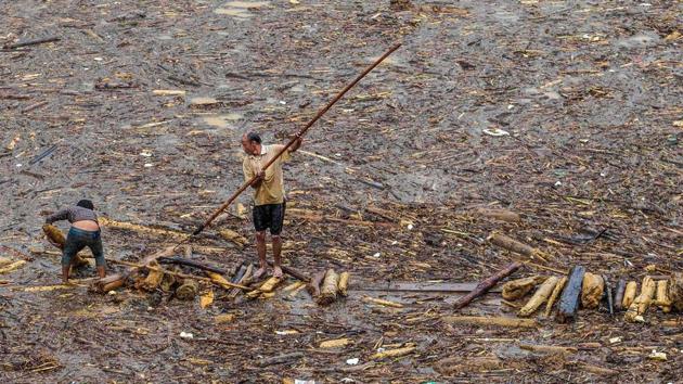 Two men collect wood from a lake filled with timber brought down from the mountains by flash floods, in the mountainous district of Mu Cang Chai in Yen Bai, Vietnam. Floods and landslides in northern Vietnam have killed at least 26 people and washed away hundreds of homes over the past week. Fifteen people are still missing. (AFP) Two men collect wood from a lake filled with timber brought down from the mountains by flash floods, in the mountainous district of Mu Cang Chai in Yen Bai, Vietnam. Floods and landslides in northern Vietnam have killed at least 26 people and washed away hundreds of homes over the past week. Fifteen people are still missing. (AFP)