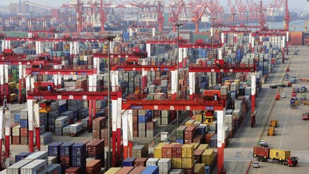 Trucks drive past piles of shipping containers at the Qingdao port in Qingdao, Shandong province June 8, 2014. (REUTERS File Photo) Trucks drive past piles of shipping containers at the Qingdao port in Qingdao, Shandong province June 8, 2014. (REUTERS File Photo)