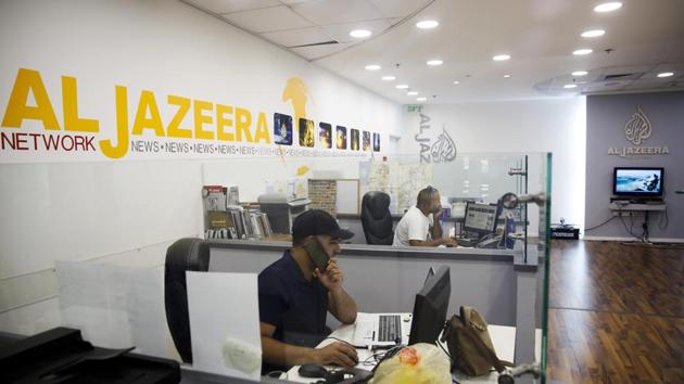 FILE- In this Tuesday, Aug. 8, 2017 file photo, employees sit in Al-Jazeera news network offices in Jerusalem. Al-Jazeera, the Qatar-based news network that broadcasts internationally in English and Arabic, has once again been thrust into the center of the story. With the network's coverage back in the spotlight after Israel's moves to block it, here's a look at what's at play. (AP) FILE- In this Tuesday, Aug. 8, 2017 file photo, employees sit in Al-Jazeera news network offices in Jerusalem. Al-Jazeera, the Qatar-based news network that broadcasts internationally in English and Arabic, has once again been thrust into the center of the story. With the network's coverage back in the spotlight after Israel's moves to block it, here's a look at what's at play. (AP)