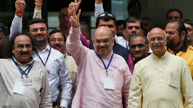 Amit Shah, President of BJP, along with his party's lawmakers gestures after casting his vote for three crucial seats in the Rajya Sabha, outside a polling centre in Gandhinagar, India, August 8, 2017. (REUTERS) Amit Shah, President of BJP, along with his party's lawmakers gestures after casting his vote for three crucial seats in the Rajya Sabha, outside a polling centre in Gandhinagar, India, August 8, 2017. (REUTERS)