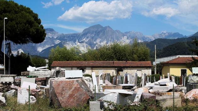 The Apuan Alps are seen in the background of a marble dealer’s warehouse, littered with slabs, slivers and blocks of marble in Carrara, Italy. While Michelangelo himself was unable to make use of the marble of his dreams, its use by artists and in architectural landmarks over the centuries --facilitated by his efforts to pave the road to extraction-- would certainly sit well with the Renaissance master. (REUTERS)