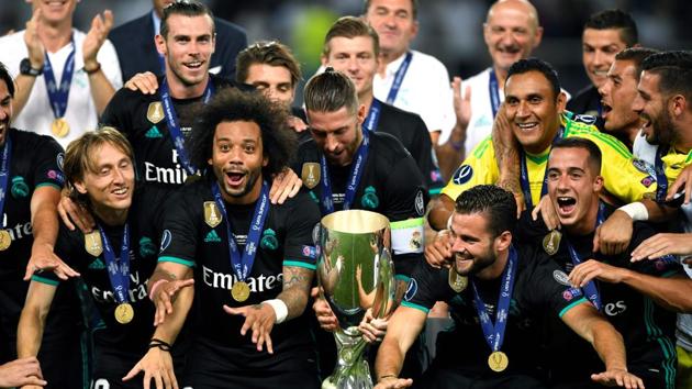Real Madrid players celebrate with the trophy after winning the UEFA Super Cup against Manchester United on Tuesday at the Philip II Arena in Skopje. (AFP) Real Madrid players celebrate with the trophy after winning the UEFA Super Cup against Manchester United on Tuesday at the Philip II Arena in Skopje. (AFP)