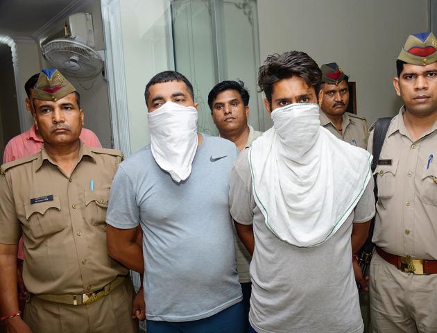 The builder and one of his accomplices after their arrest on Wednesday. (Sakib Ali/HT PHOTO) The builder and one of his accomplices after their arrest on Wednesday. (Sakib Ali/HT PHOTO)