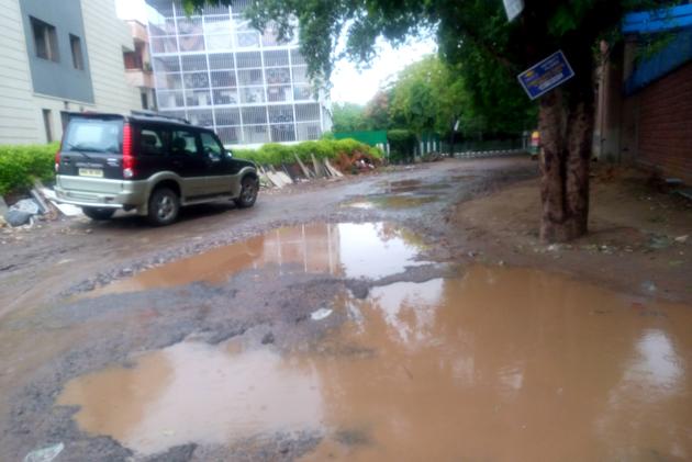 Badly damaged road due to water logging in DLF Phase-1 area. (HT Photo) Badly damaged road due to water logging in DLF Phase-1 area. (HT Photo)