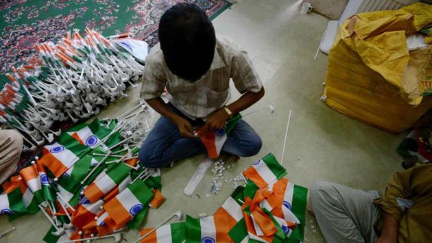 A worker prepares Indian national flags at a workshop in New Delhi. (Money Sharma/AFP)