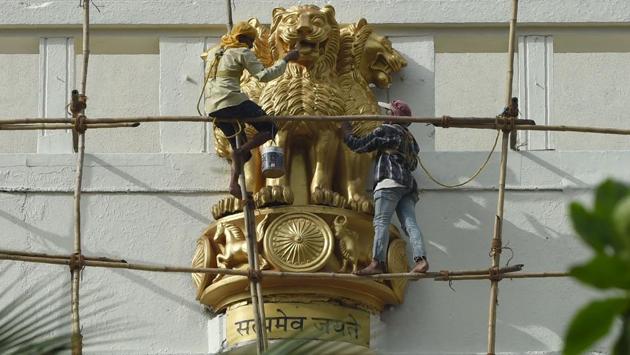 Workers paint a statue of the national emblem, a depiction of the Sarnath Lion Capital of Ashoka, ahead of the 70th year of independence at the state secretariat building in Mumbai, Maharashtra. (Indranil Mukherjee/AFP)