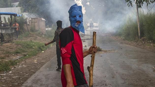 A masked villager holds a wooden stick and stones during a protest following the funeral procession of Akeel Ahmed Bhat, a teenage boy in Haal village, south of Srinagar, Kashmir, Wednesday, Aug. 2, 2017. (AP) A masked villager holds a wooden stick and stones during a protest following the funeral procession of Akeel Ahmed Bhat, a teenage boy in Haal village, south of Srinagar, Kashmir, Wednesday, Aug. 2, 2017. (AP)
