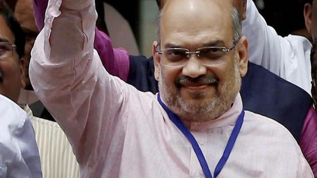 BJP president Amit Shah flashes the victory sign after casting his vote in Gujarat Rajya Sabha election in Gandhinagar on Tuesday. The party chief won a seat in the Upper House. (PTI Photo) BJP president Amit Shah flashes the victory sign after casting his vote in Gujarat Rajya Sabha election in Gandhinagar on Tuesday. The party chief won a seat in the Upper House. (PTI Photo)