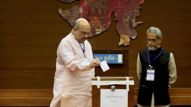Bharatiya Janata Party president Amit Shah casts his vote during the Rajya Sabha election at the secretariat in Gandhinagar on Tuesday. (PTI) Bharatiya Janata Party president Amit Shah casts his vote during the Rajya Sabha election at the secretariat in Gandhinagar on Tuesday. (PTI)