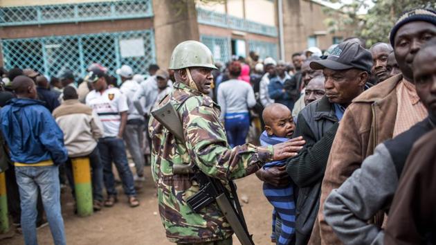 A Kenya Administration police officer monitors access to a polling station at Kariokor Community Centre in Nairobi during general elections. Efforts were made to head off potential violence once voting ended. The two leading candidates made pleas for peace and even former US President Barack Obama, whose father was born in the country called on Kenyans to reject violence. (Luis Tato/AFP)