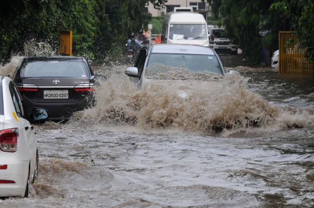Cars ply through a water logged road after heavy rain in sector-31. (Parveen Kumar/HT Photo) Cars ply through a water logged road after heavy rain in sector-31. (Parveen Kumar/HT Photo)