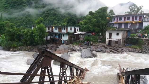 A bridge, connecting Pithoragarh to Munsiari, collapsed after the water in local rivulet Gosi rose sharply due to heavy rains triggered by the cloudburst.(Devendra/HT Photo)