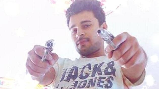 Deepak Kumar Malik has uploaded several photographs on his Facebook page posing with guns and other arms.(HT Photo)