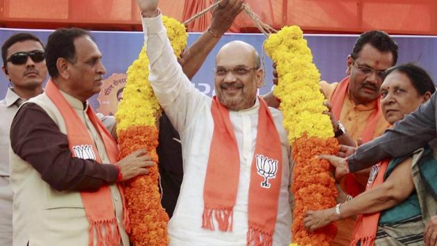 Gujarat Chief Minister Vijay Rupani and former chief minister Anandiben Patel and other BJP leaders felicitate party president Amit Shah for winning Rajya Sabha election, at party office in Gandhinagar on Wednesday. (PTI) Gujarat Chief Minister Vijay Rupani and former chief minister Anandiben Patel and other BJP leaders felicitate party president Amit Shah for winning Rajya Sabha election, at party office in Gandhinagar on Wednesday. (PTI)