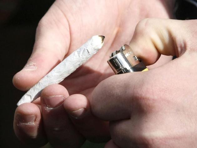 A man lights a cigarette rolled with marijuana. (Reuters File Photo) A man lights a cigarette rolled with marijuana. (Reuters File Photo)