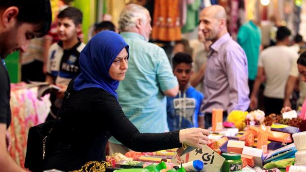 An Iraqi woman shops in the souk in the East of Mosul, Iraq. As coalition forces reached the eastern part of Mosul, retaking it earlier in the year life sprang back up with markets, vendors and businesses emerging along blown up, debris riddled streets. (REUTERS)