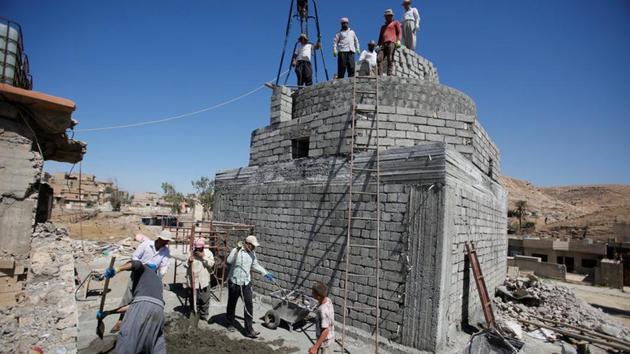 Workers rebuild a Yazidi shrine, after is was destroyed by Islamic State, in Bashiqa, a town near Mosul, Iraq August 8, 2017.(REUTERS Photo)