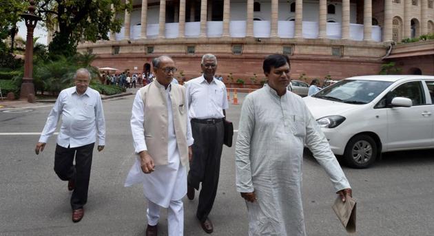 Congress leader Digvijay Singh and CPI member D Raja with JDU leader Ali Anwar Ansari leave after attending the monsoon session at Parliament in New Delhi.(PTI File Photo)