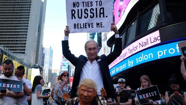 Protesters display placard against US President Donald Trump during a demonstration in front of the US Army career centre in Times Square, New York, on July 26, 2017. (AFP Photo) Protesters display placard against US President Donald Trump during a demonstration in front of the US Army career centre in Times Square, New York, on July 26, 2017. (AFP Photo)