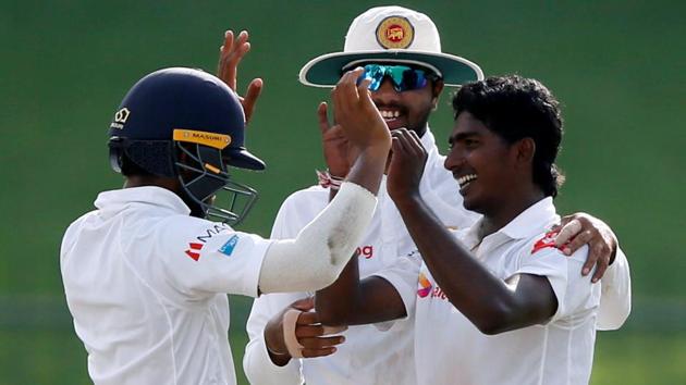 Sri Lanka’s Lakshan Sandakan celebrates with captain Dinesh Chandimal and Kusal Mendis after taking the wicket of India’s captain Virat Kohli. (REUTERS) Sri Lanka’s Lakshan Sandakan celebrates with captain Dinesh Chandimal and Kusal Mendis after taking the wicket of India’s captain Virat Kohli. (REUTERS)