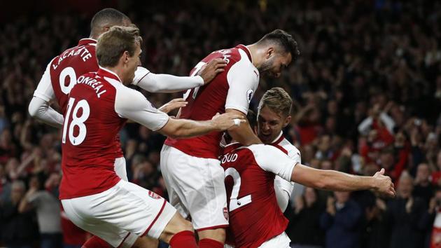 Arsenal's French striker Olivier Giroud (2nd R) celebrates with teammates after scoring Arsenal's fourth goal during the Premier League season opener against Leicester City at the Emirates Stadium on Friday. (AFP)