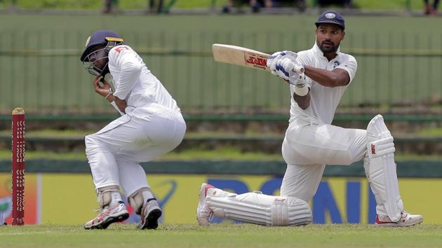 Sri Lanka's Kusal Mendis, left, reacts after a shot played by India's Shikhar Dhawan. (AP)