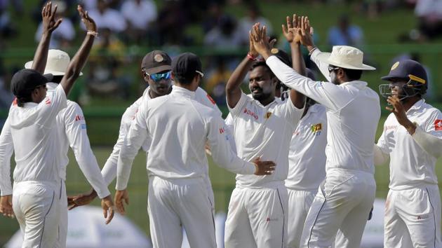 Sri Lanka's Malinda Pushpakumara, center without cap, celebrates with teammates the dismissal of India's Ajinkya Rahane. (AP)